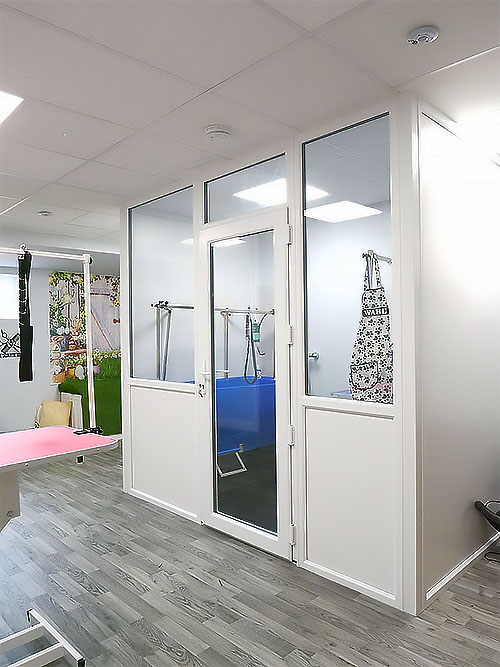 Enclosed bathing room with apron hanging up in the window